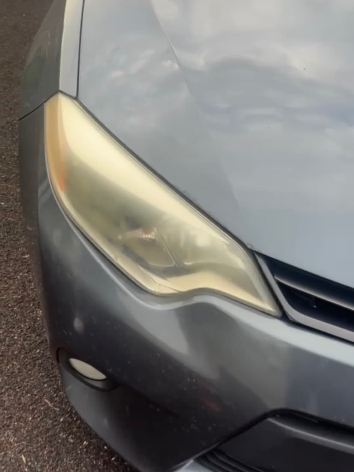 Yellowed, oxidized headlight lens with hazy plastic before restoration